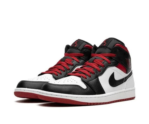 The red upper of the Air Jordan 1 Mid Gym Red Black Toe contrasts with the black toe box, collar, and Swoosh. Both durability and an opulent feel are provided by its superior leather structure, available at Cop Underdog In-store and ready to ship.