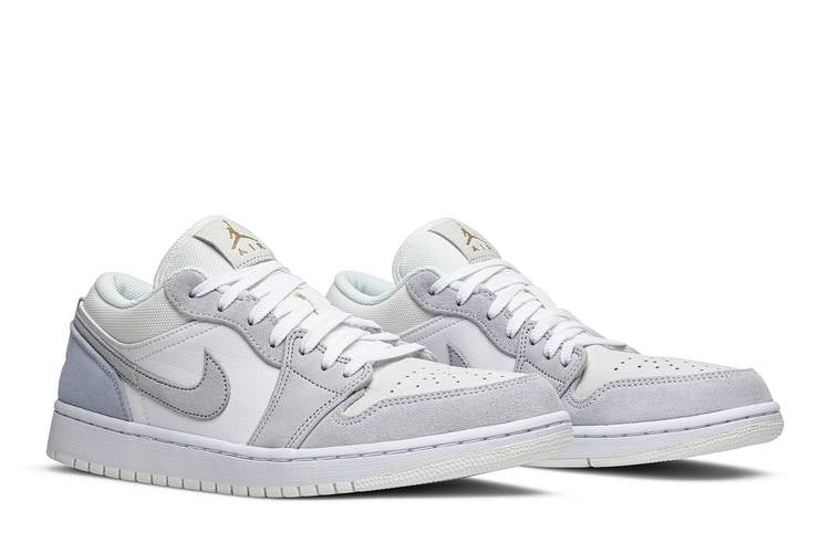 This J1 Low features a white, Sky Grey, and Football Grey textile, leather, and suede upper, with smooth leather making a minimal appearance in white on the quarter panels of the shoe, available at Cop Underdog In-store and ready to ship.